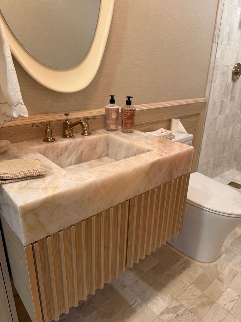 Custom fluted oak vanity with onyx sink