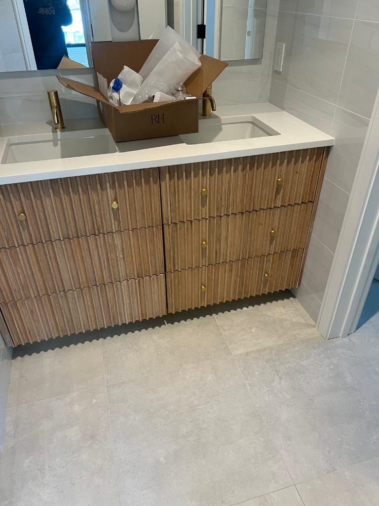 Fluted double vanity drawers with brass pulls
