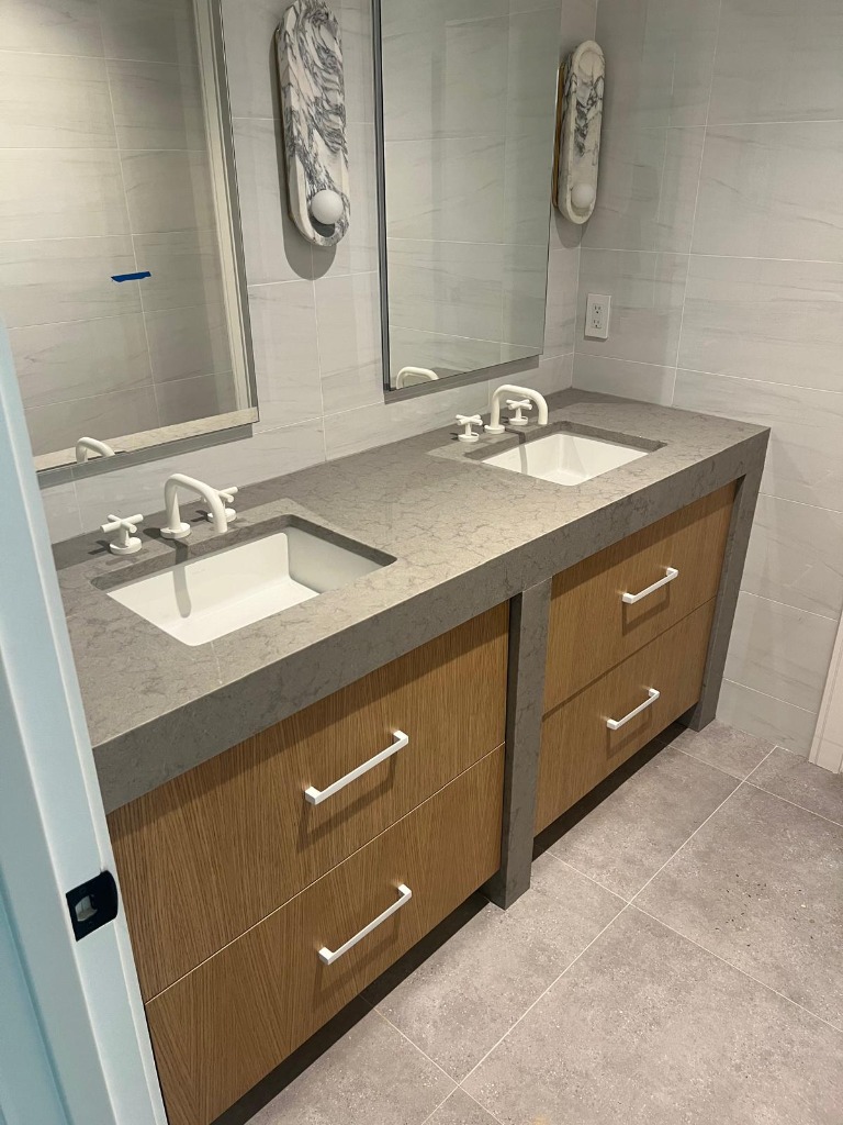 Modern floating oak vanity with stone wrap